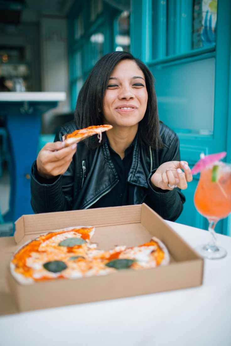 woman eating pizza